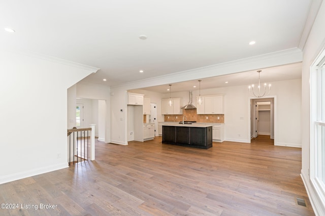 6715 Hypoint Ridge Rd, Crestwood, KY 40014 - kitchen with light countertops, light wood-style flooring, wall chimney range hood, visible vents, and a kitchen island with sink