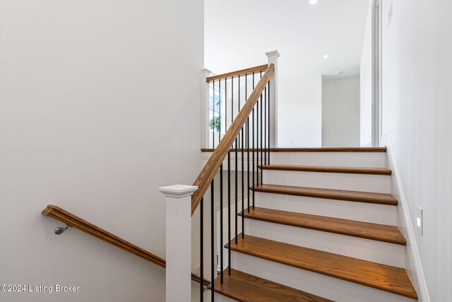 stairway featuring hardwood / wood-style flooring