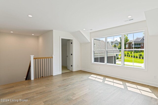 bonus room with light wood-type flooring