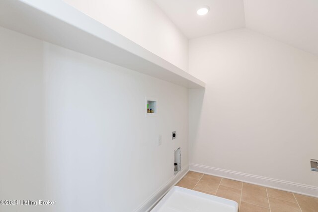 laundry room featuring washer hookup, electric dryer hookup, and light tile patterned flooring