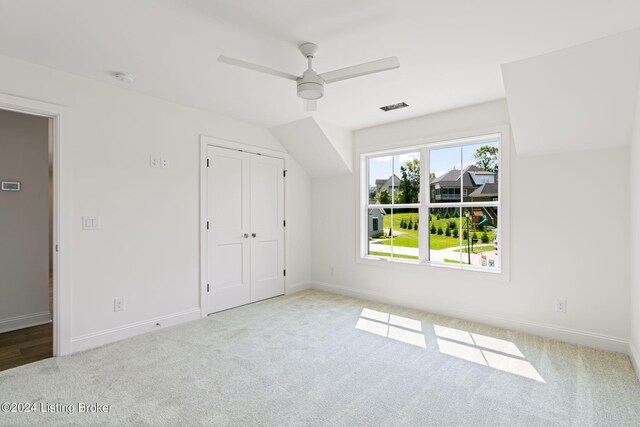 unfurnished bedroom with a closet, ceiling fan, and light colored carpet