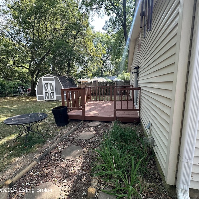 view of yard featuring a storage shed and a deck