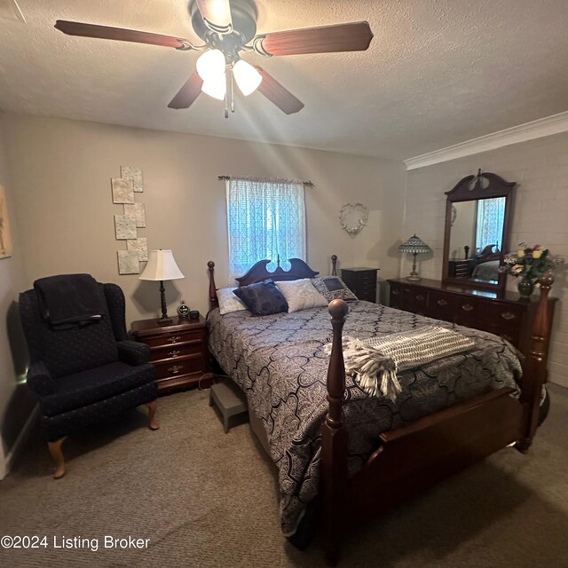 carpeted bedroom featuring a textured ceiling, crown molding, and ceiling fan