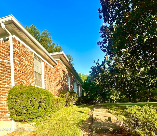 view of side of property with a yard