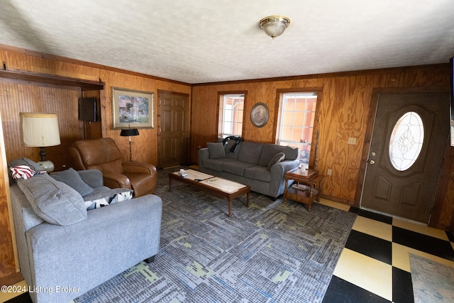 living room featuring ornamental molding and wood walls