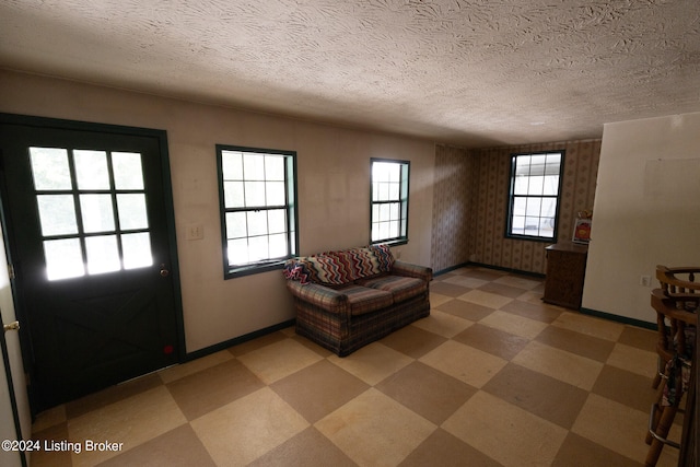 interior space featuring plenty of natural light and a textured ceiling