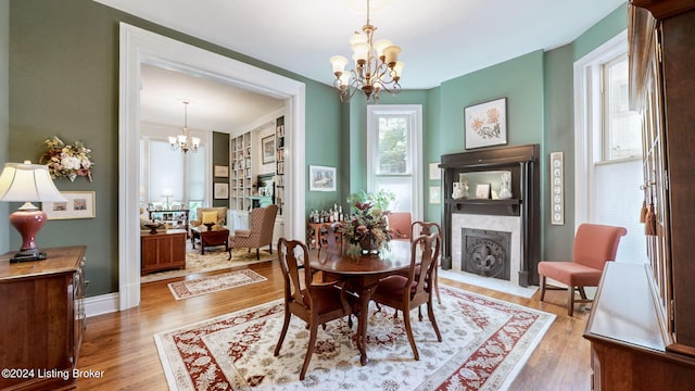 dining room with hardwood / wood-style floors and a chandelier