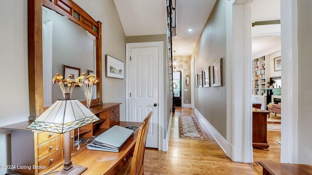 hall with light hardwood / wood-style floors and lofted ceiling