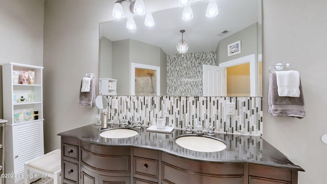 bathroom with decorative backsplash and vanity