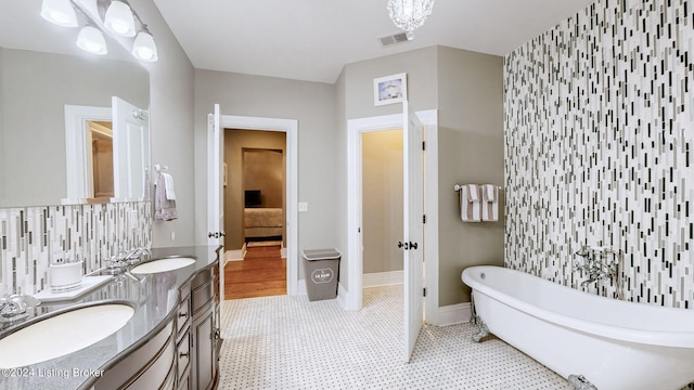 bathroom featuring vanity and a washtub