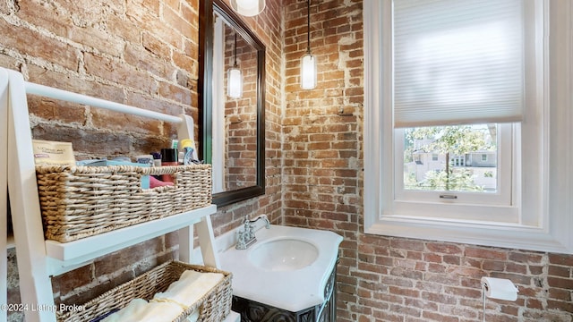 bathroom with brick wall and sink