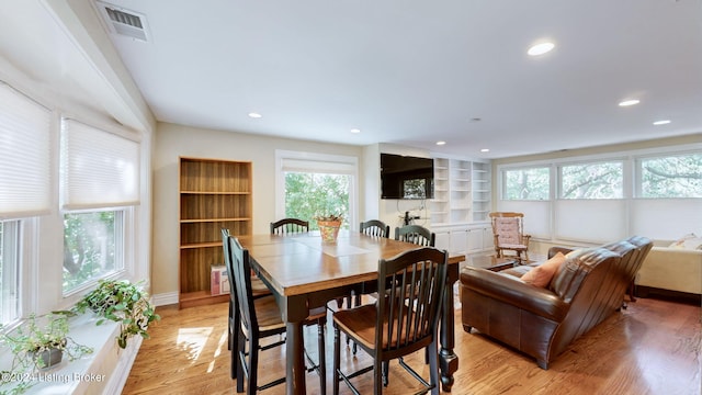 dining room with light hardwood / wood-style flooring and plenty of natural light