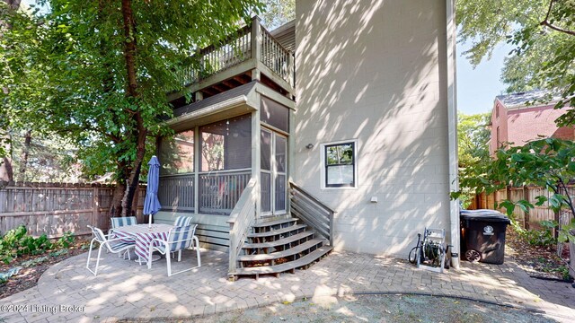 exterior space featuring a sunroom and a patio area