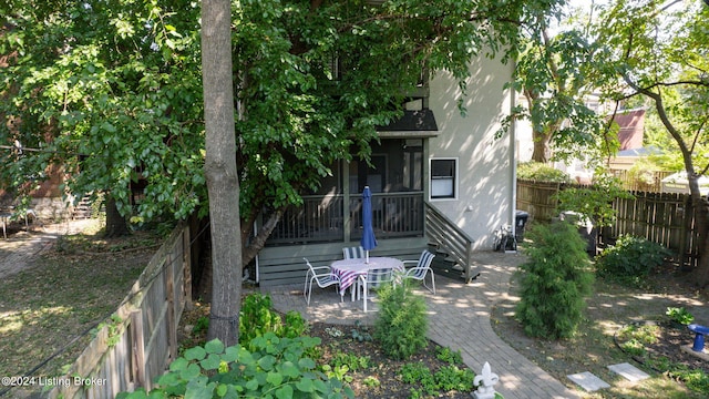 rear view of house featuring a sunroom and a patio area