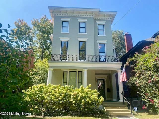 italianate home featuring a balcony and a porch