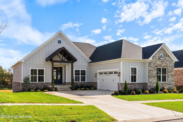 view of front of home with a front lawn and a garage