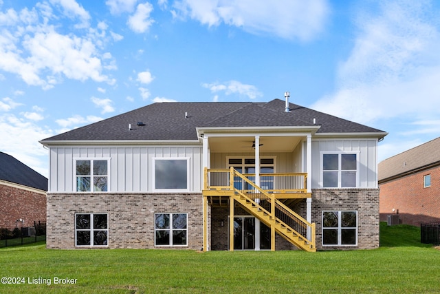 rear view of house featuring a yard and ceiling fan