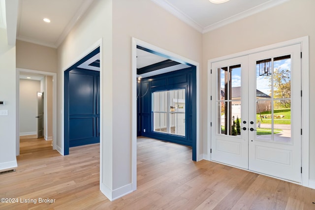 entryway featuring light hardwood / wood-style flooring, ornamental molding, and french doors