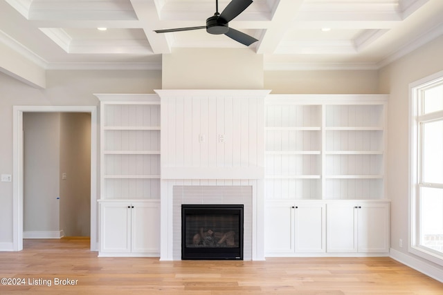 unfurnished living room with light hardwood / wood-style flooring, beam ceiling, coffered ceiling, and crown molding