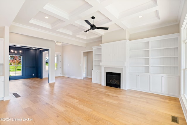 unfurnished living room featuring beamed ceiling, coffered ceiling, crown molding, and light wood-type flooring