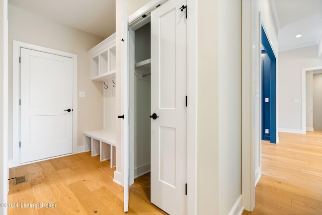 mudroom with light hardwood / wood-style flooring