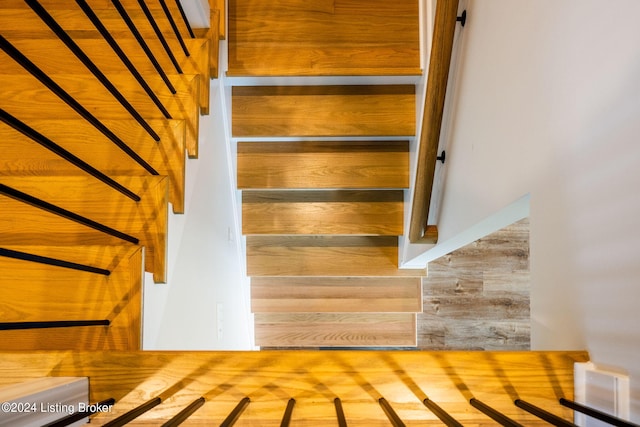 stairs with hardwood / wood-style floors