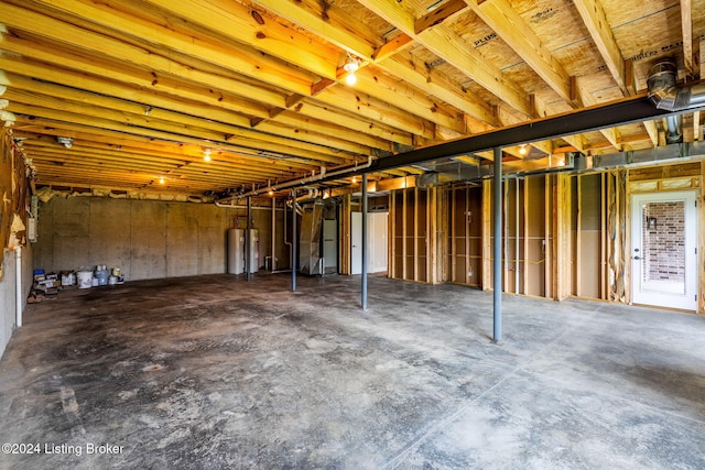 basement featuring water heater and electric water heater