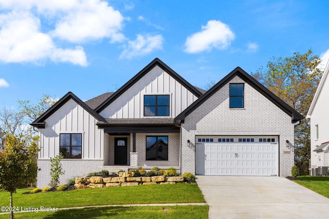 3322 Catalpa Farms Dr, Fisherville, KY 40023 - view of front facade with board and batten siding, concrete driveway, brick siding, a front yard, and covered porch