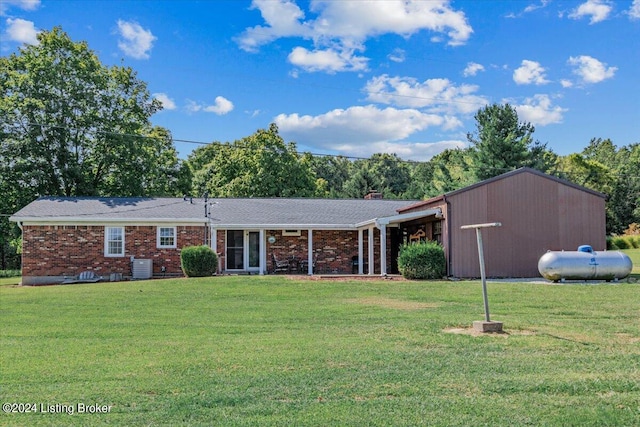 single story home with central AC unit and a front yard