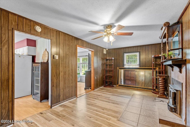 interior space featuring a textured ceiling, ceiling fan, and light hardwood / wood-style floors