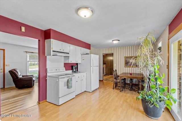 kitchen with a textured ceiling, light wood-type flooring, white appliances, and white cabinets