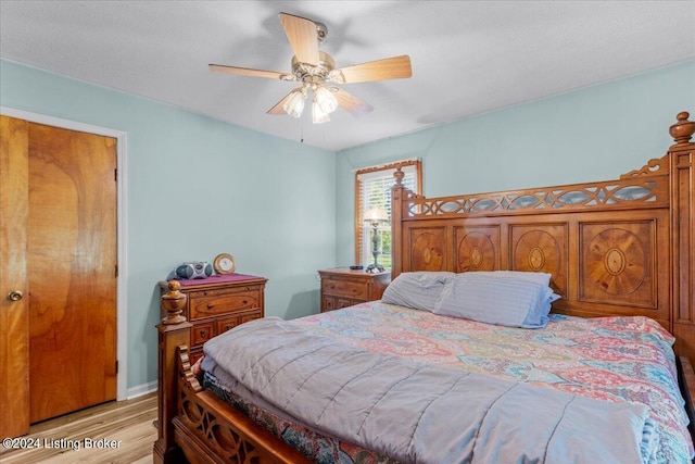 bedroom with ceiling fan and light hardwood / wood-style floors