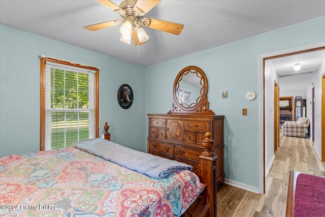 bedroom featuring light wood-type flooring and ceiling fan