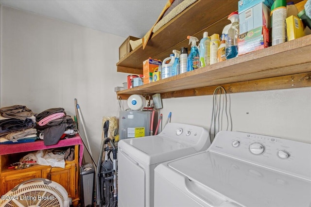 laundry room featuring electric water heater and washer and dryer