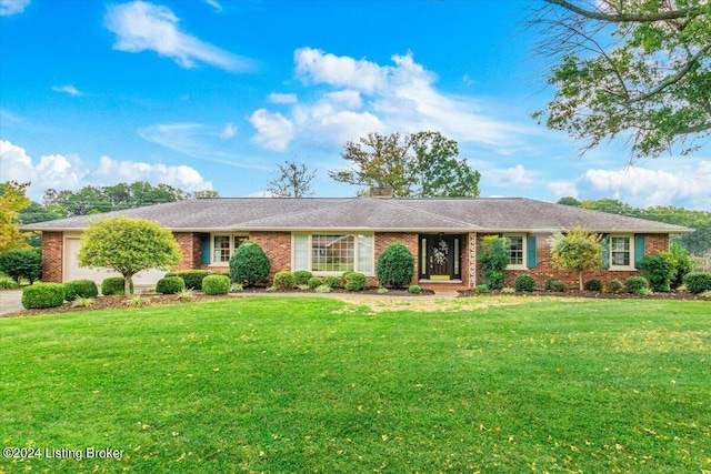 single story home featuring brick siding, an attached garage, driveway, and a front yard