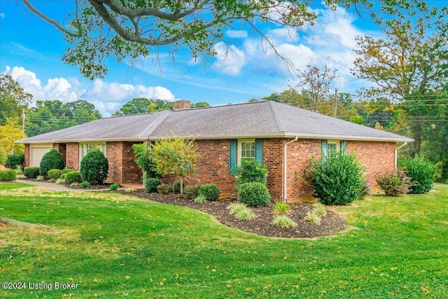 view of property exterior with brick siding, a garage, a chimney, and a yard