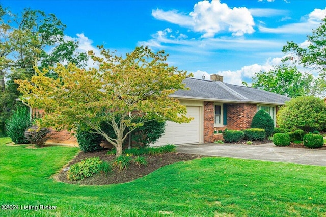 view of front of property featuring driveway, a front lawn, an attached garage, brick siding, and a chimney