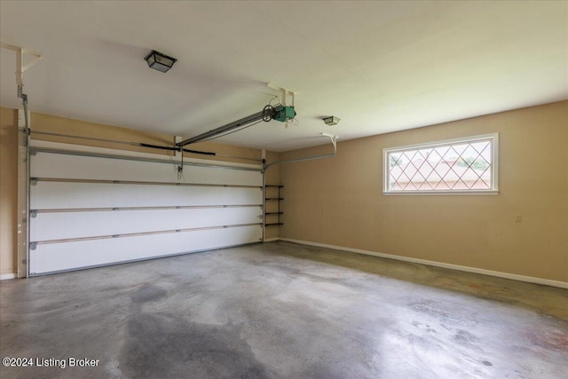 garage featuring a garage door opener and baseboards