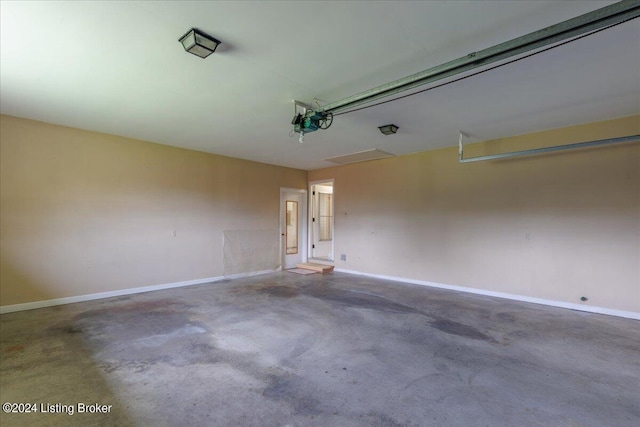 garage featuring a garage door opener and baseboards