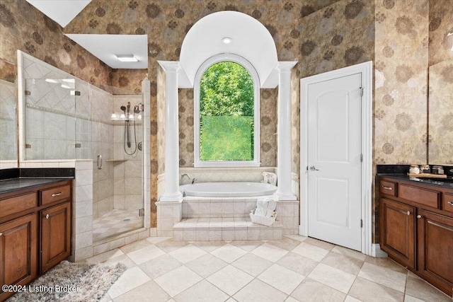 bathroom with vanity, ornate columns, wallpapered walls, a shower stall, and a bath