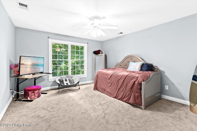 bedroom featuring visible vents, baseboards, carpet, and a ceiling fan