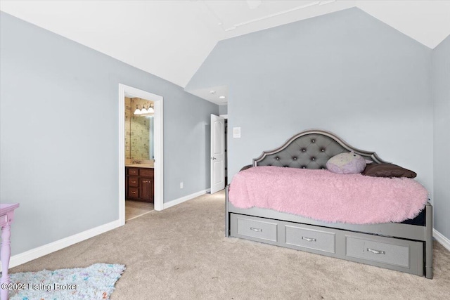 carpeted bedroom featuring baseboards, lofted ceiling, and connected bathroom