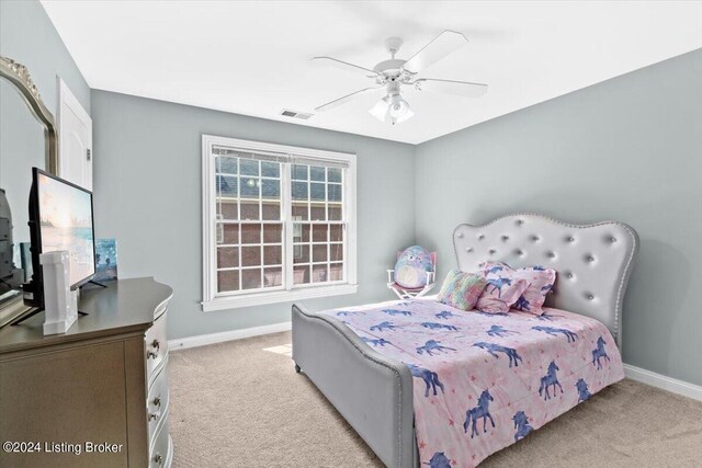 bedroom featuring light colored carpet and ceiling fan