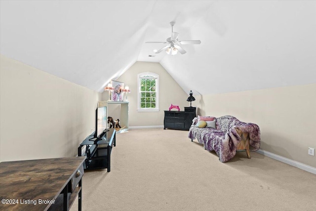 interior space featuring lofted ceiling, carpet, baseboards, and ceiling fan