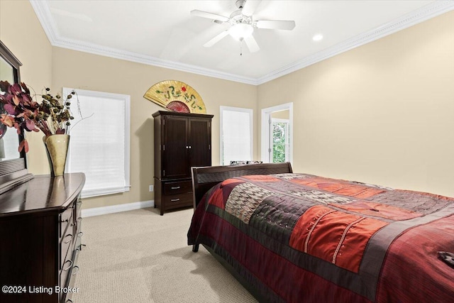 bedroom featuring ceiling fan, crown molding, and light carpet