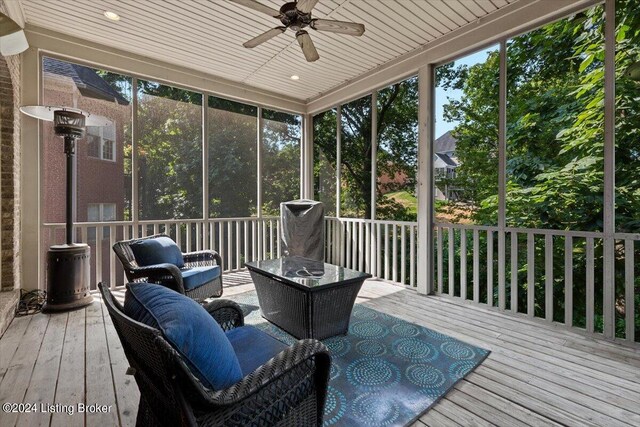 deck with ceiling fan and an outdoor living space