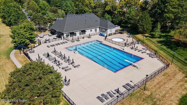 view of swimming pool with a patio area and a lawn