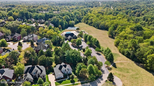 birds eye view of property featuring a residential view and a forest view