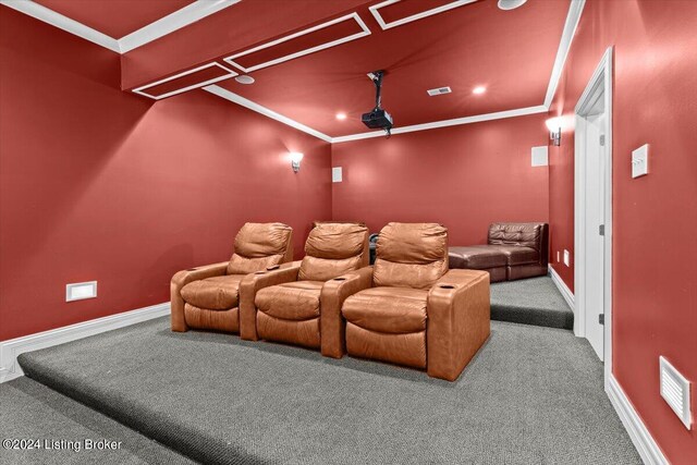 home theater room featuring ornamental molding and carpet flooring