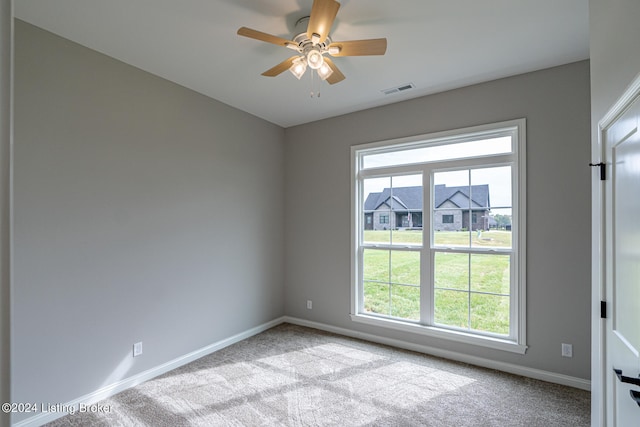 spare room with light carpet and ceiling fan